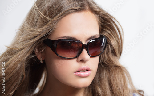 Close up young woman wearing the big modern sunglasses