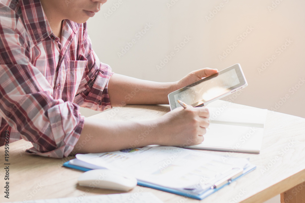asian entrepreneur planning business marketing budget and checking material from internet. asian entrepreneur planning business marketing budget and checking material from internet.