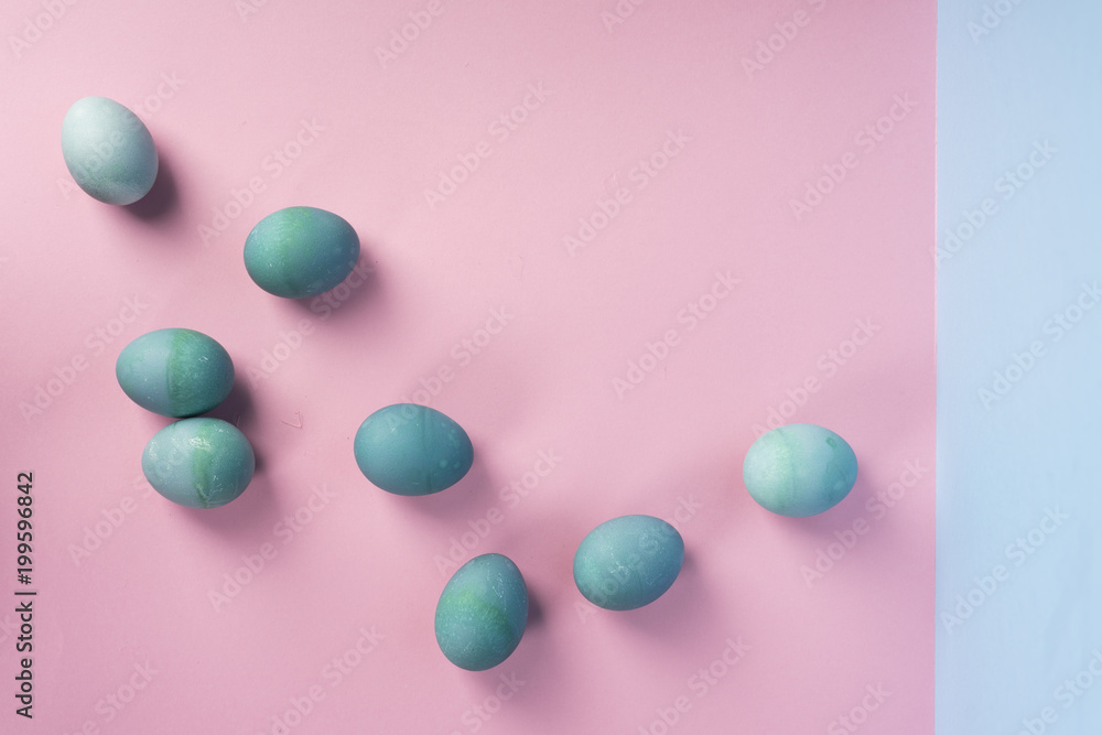 Several different shades blue eggs on the geometric pink and blue background. Several different shades blue eggs on the geometric pink and blue background.