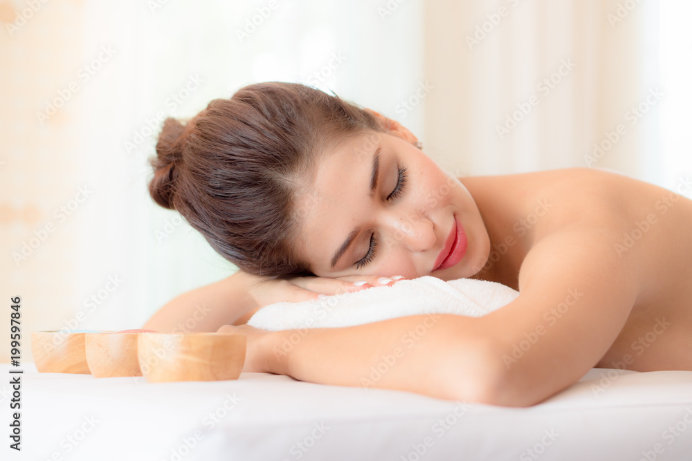 Beautiful woman lying down on the bed relax in spa salon with salt massage. Beautiful woman lying down on the bed relax in spa salon with salt massage.