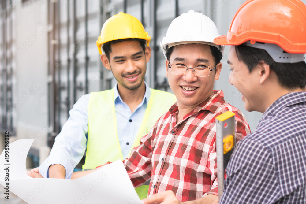 Concept Teamwork of building construction staff. Project engineer / contractor reviewing plan of work with foreman and worker at construction site. Concept Teamwork of building construction staff. Project engineer / contractor reviewing plan of work with foreman and worker at construction site.