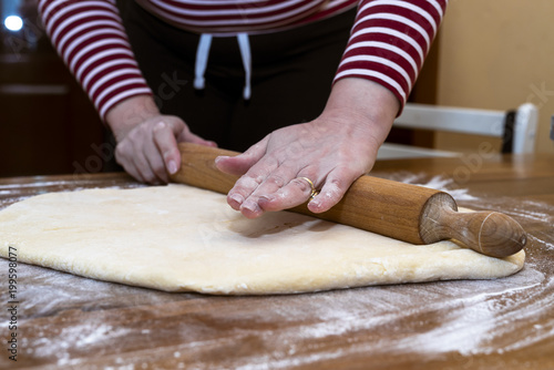 Women's hands prepare a donut dough