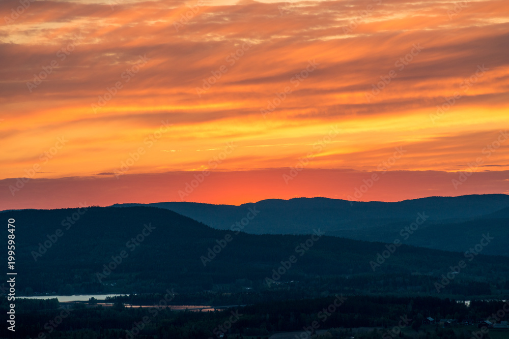 Burning sunset mountain silhouette
