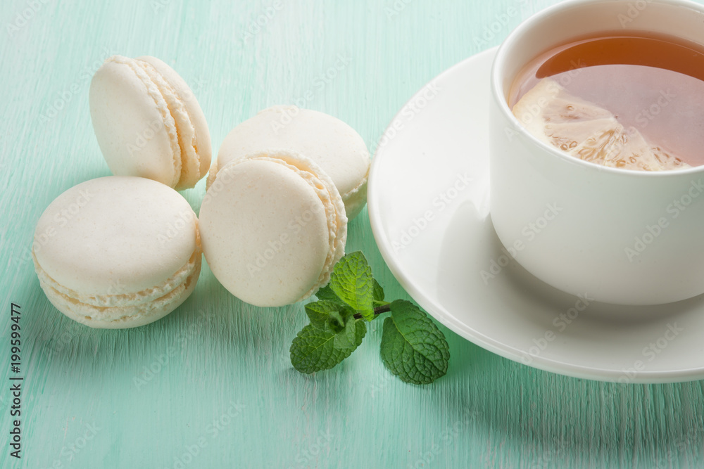 Tea with mint and lemon and white macaroons with mint Tea with mint and lemon and white macaroons with mint