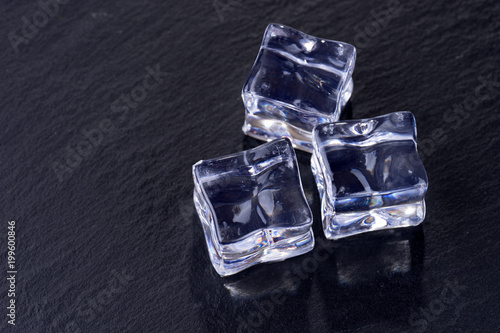 Three ice cubes isolated on black background