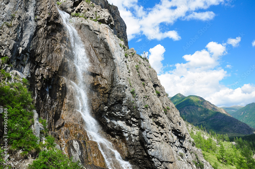 Waterfall on the rock. Named - Shirlak - Girl's tears . Altai, Siberia, Russia. Waterfall on the rock. Named - Shirlak - Girl's tears . Altai, Siberia, Russia.