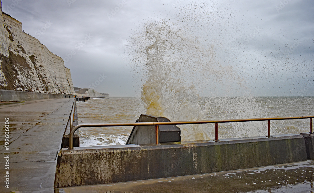 A wave splashes brightly against the coastal steps