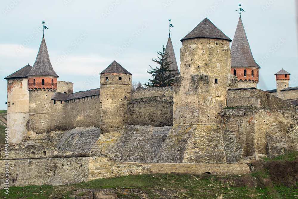 Kamianets Podilskyi fortress built in the 14th century. View of the  fortress wall with towers at early springtime, Ukraine