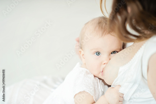 Baby eating mother's milk. Mother breastfeeding baby.