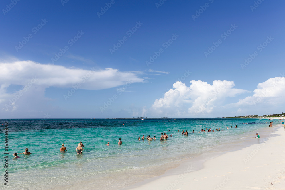 People relaxing on the beach .