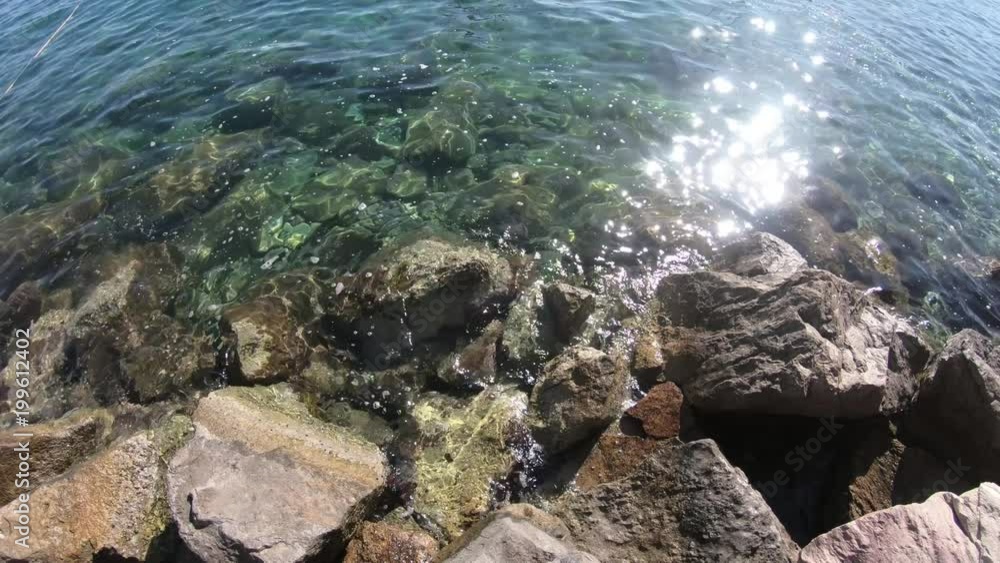 Sea waves splashing on background stone. Waves water splashing about stone protruding from sea. Close up sea waves of water on background Stone Sea waves splashing on background stone. Waves water splashing about stone protruding from sea. Close up sea waves of water on background Stone