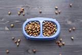 Pet food for dog or cat in bowl on wooden background top view flat lay
