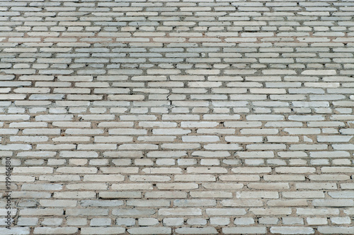 Grey texture of brick wall made of old silicate bricks.