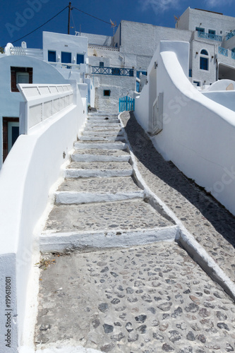 Traditional Greek stone stairway leading up to an island village on a hill on the island of Santorini, Greece. No people; copy space.