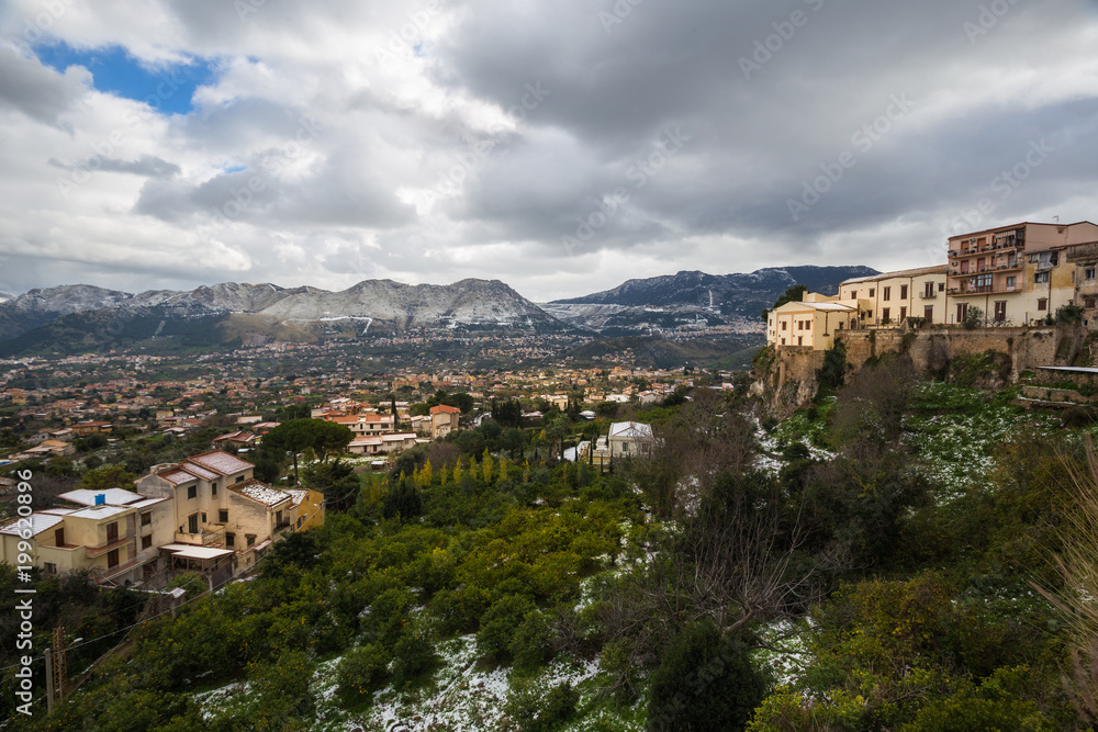 View of the outskirts of Palermo and the surrounding snow dusted mountains from Monreale.