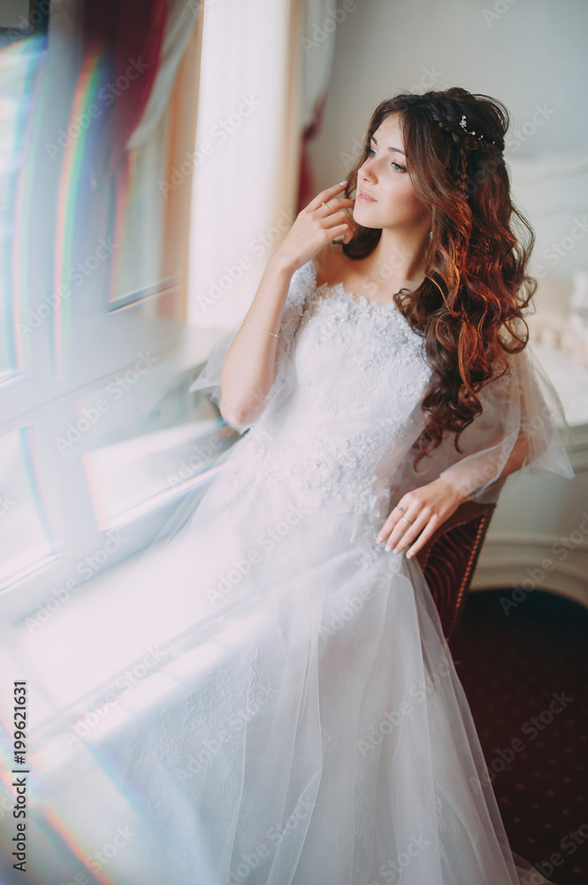 beautiful bride posing in a hotel on a chair beautiful bride posing in a hotel on a chair