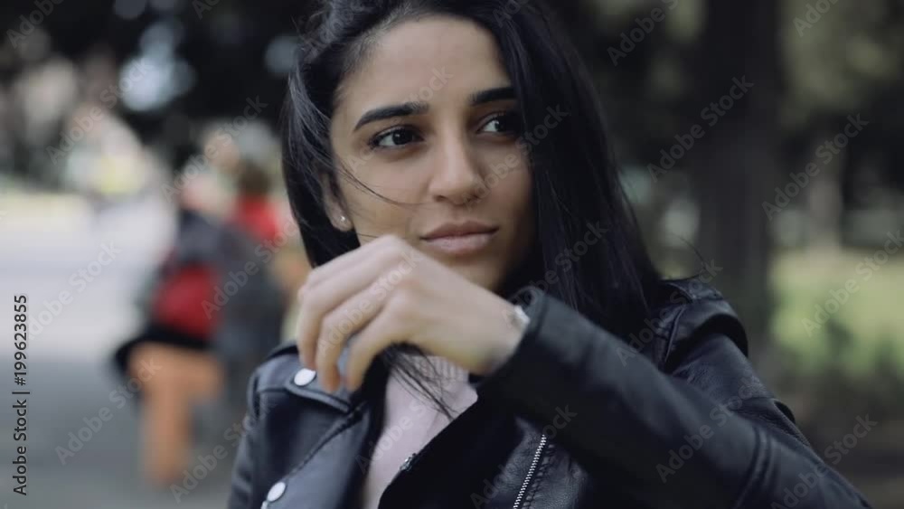 Cute pretty woman sitting on bench leaning head on hand Cute pretty woman sitting on bench leaning head on hand