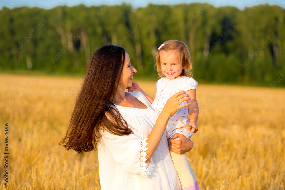 Mom and daughter walking in the grain fields Mom and daughter walking in the grain fields