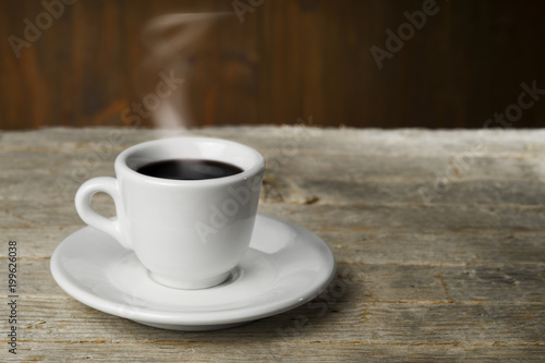 Cup of coffee on wooden table 