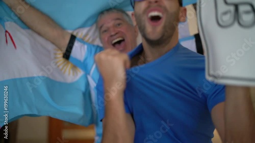 Argentina Father and Son Fans Watching and Celebrating a Soccer Game