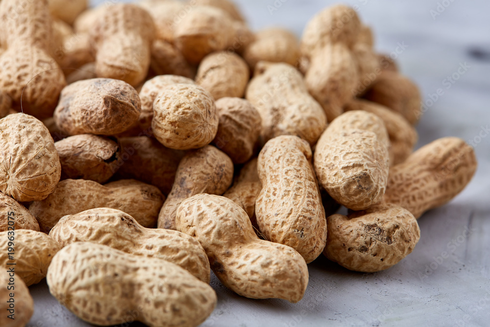Pile of shelled peanuts isolated on white background, top view, close-up, vertical, shallow depth of field Pile of shelled peanuts isolated on white background, top view, close-up, vertical, shallow depth of field