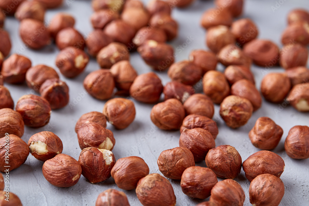 Raw hazelnut on heap isolated on white background, selective focus, shallow depth of field Raw hazelnut on heap isolated on white background, selective focus, shallow depth of field