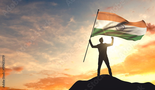 Canvas Print India flag being waved by a man celebrating success at the top of a mountain