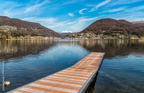 Landscape of lake Lugano and Swiss Alps from Lavena Ponte Tresa  province of Varese  Italy