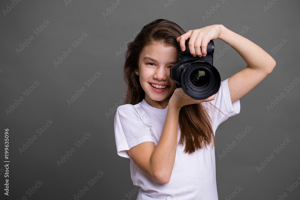 Cute brunette little girl holding an photo camera Cute brunette little girl holding an photo camera