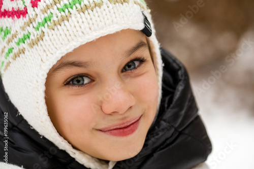 Close up portrait of a cute little girl in winter time