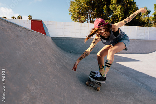Woman practising skateboarding at skate park