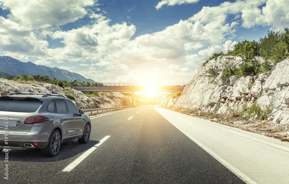 Car rushing along a high-speed highway in the sun. Car rushing along a high-speed highway in the sun.
