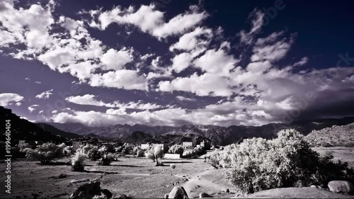 Clouds move over the central part of the Anti-Atlas mountains near the ancient town of Tafraout, Morocco, known for the Ameln Valley. Infrared as a time lapse. Infrared time-lapse. photo