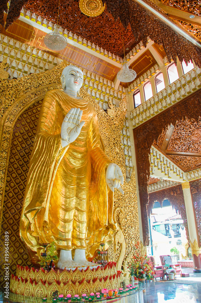 Standing Buddha statue in Dhammikarama Burmese temple  in Penang, Malaysia