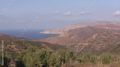 Coastline with mediterranean sea of Crete in Greece with vegetation and olive trees. photo