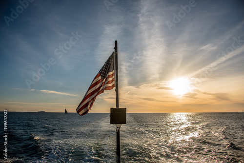 American flag flying from a sailboat at sea
