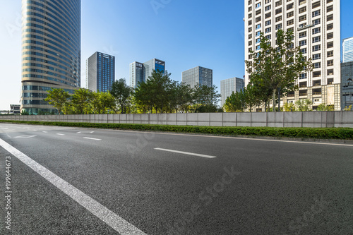 city empty traffic road with cityscape in background. © hallojulie