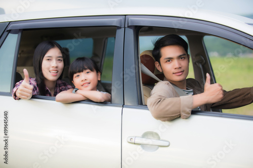 Happy little girl  with asian family sitting in the car for enjoying road trip and summer vacation in camper van © tuiphotoengineer