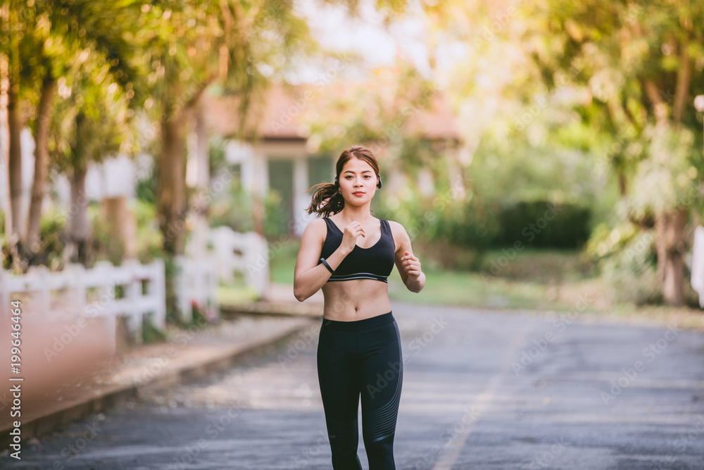 Asian women Running and jogging during outdoor on road in park Asian women Running and jogging during outdoor on road in park