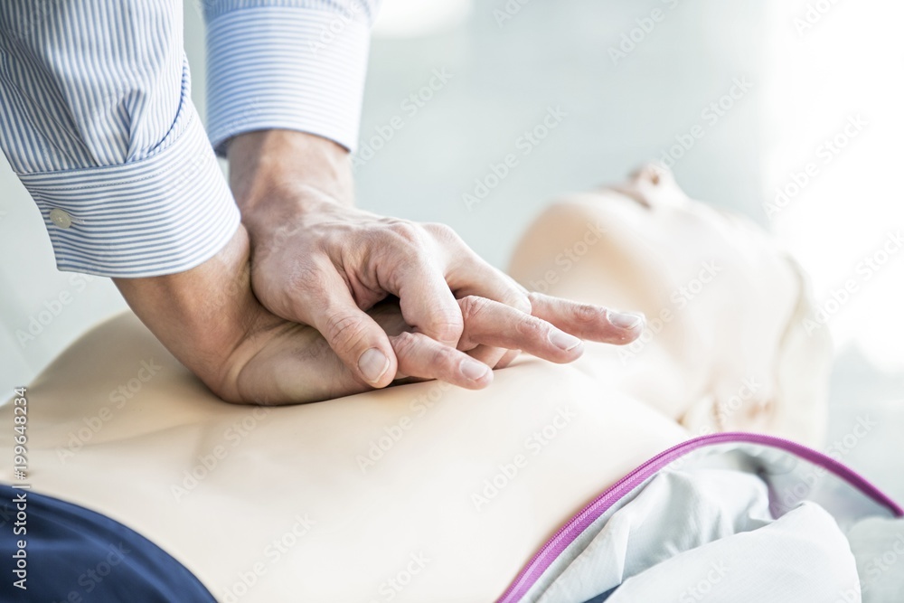 First-aider practising chest compressions First-aider practising chest compressions
