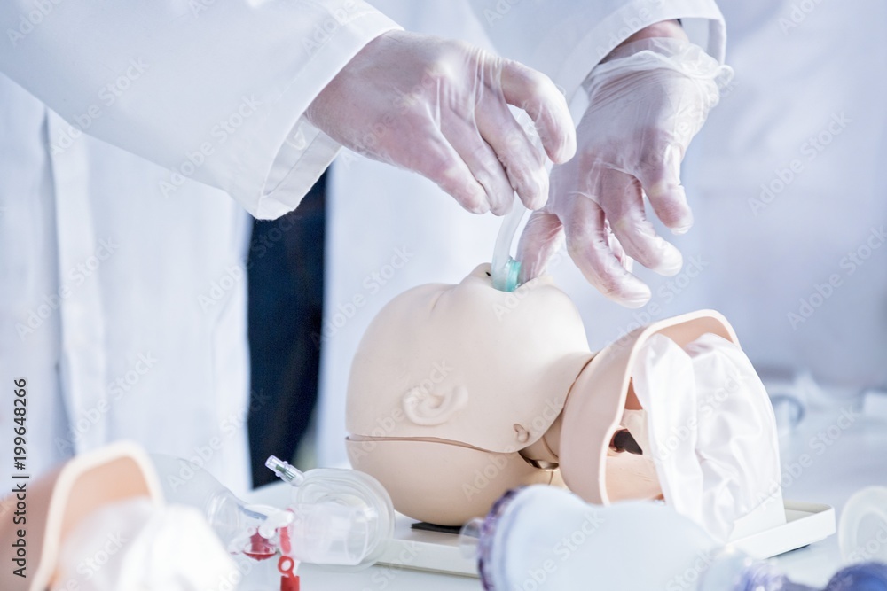 Doctors practising infant intubation Doctors practising infant intubation