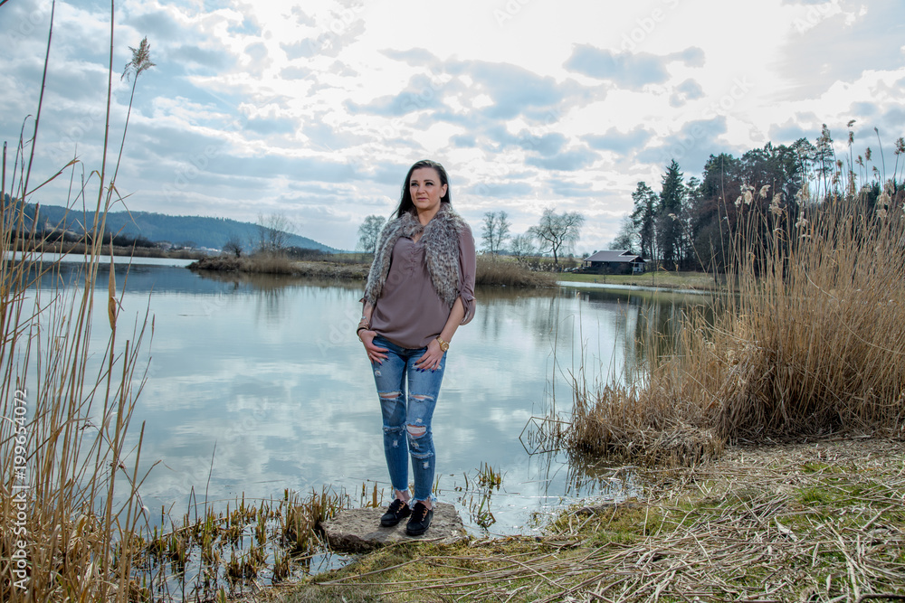 Portrait of young happy brunette girl in jeans Portrait of young happy brunette girl in jeans