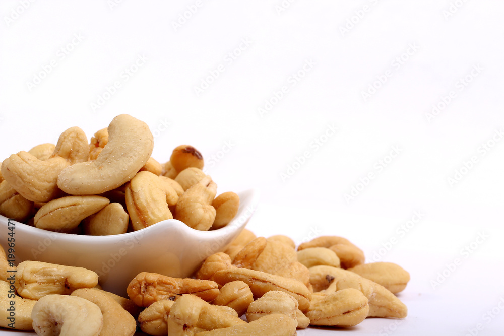 Unshelled roasted and salted cashew nuts isolated on white background Unshelled roasted and salted cashew nuts isolated on white background