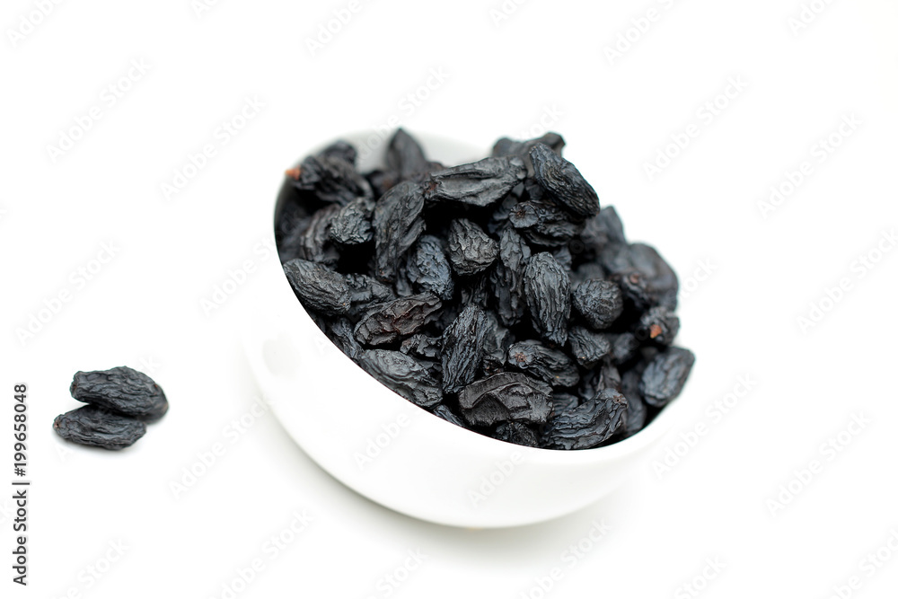 black raisins on white background black raisins on white background