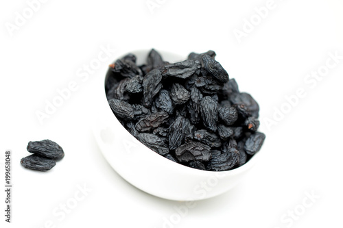 black raisins on white background