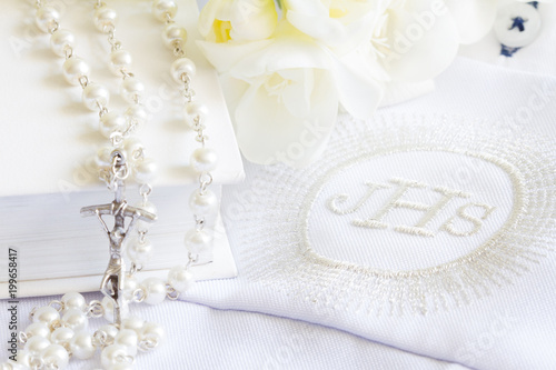 First holy communion symbol background concept with rosary and flowers
