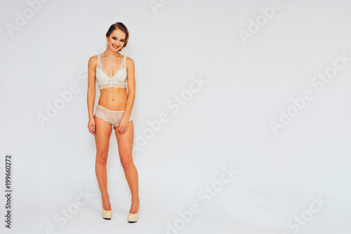 beautiful young girl in a swimsuit and in underwear in different poses demonstrate different emotions