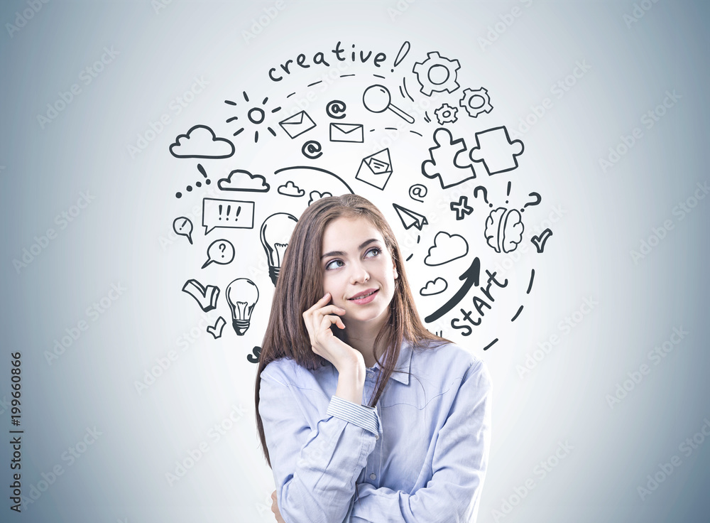Dreamy young woman in a blue shirt, creative thinking Dreamy young woman in a blue shirt, creative thinking