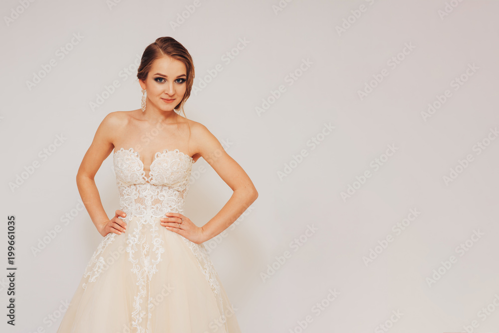 beautiful young bride in a wedding dress demonstrates different poses beautiful young bride in a wedding dress demonstrates different poses