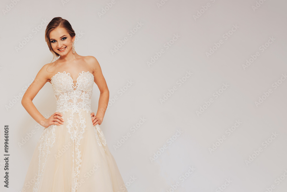 beautiful young bride in a wedding dress demonstrates different poses beautiful young bride in a wedding dress demonstrates different poses